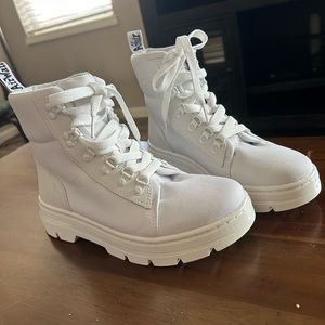 White canvas Dr. Marten combat boots.